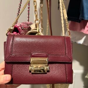 Burgundi color Michael Kors purse. Authentic, rare find. Can be worn belted